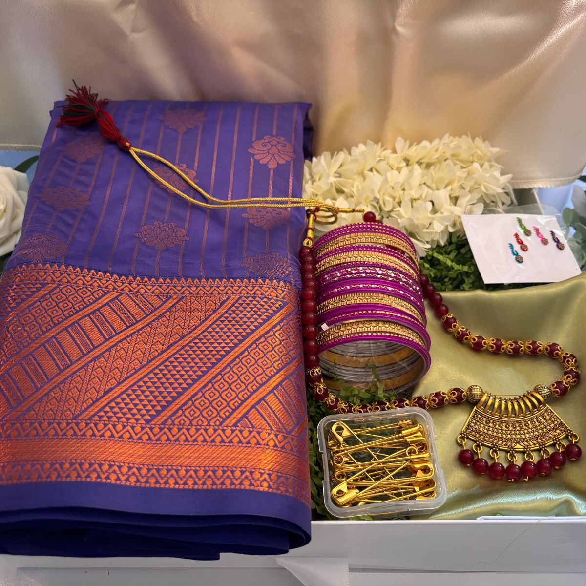 Tamil bridesmaid gift box with Kanjeevaram silk saree, temple jewellery, jasmine flowers, and bangles